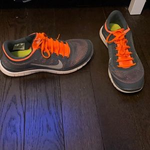 Orange and gray Nike running shoes